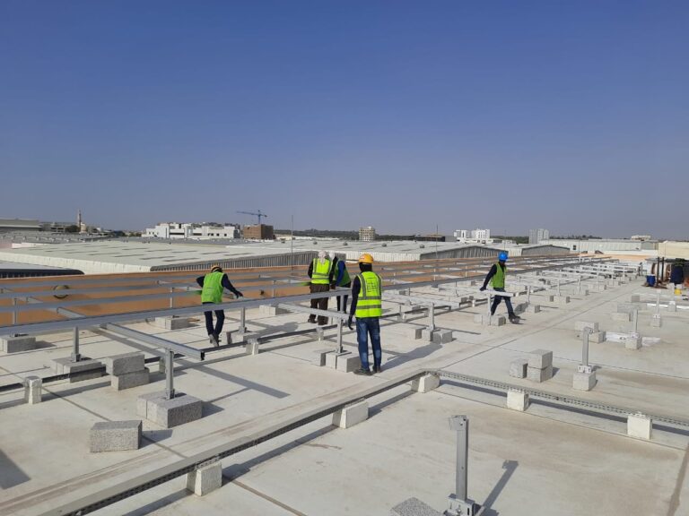 Workers installing Rooftop based Solar PV Structure on Flat roof tops