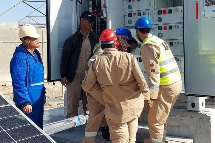 Employees Fixing Batteries in a Container based BESS Site